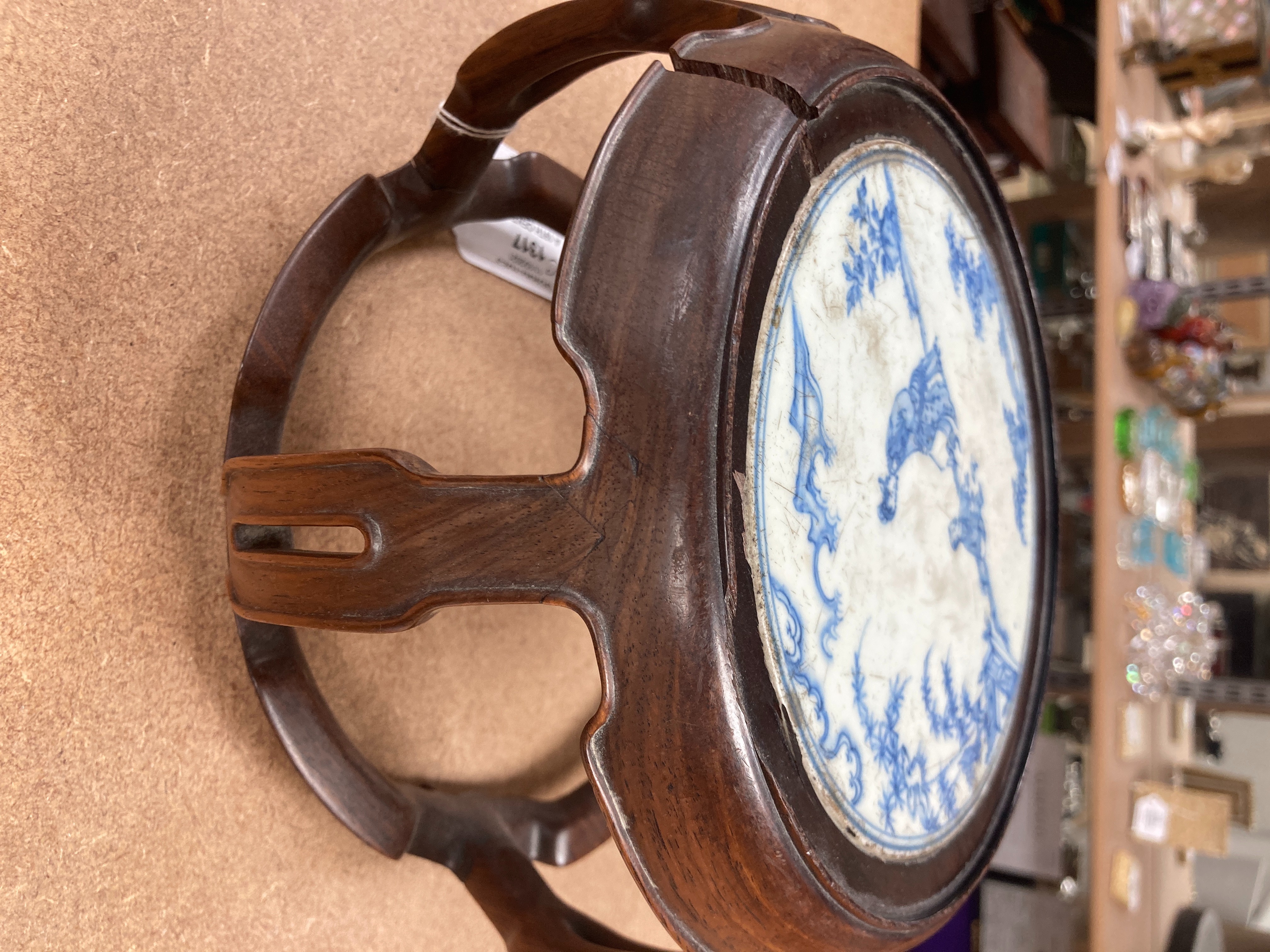 A 19th century Chinese blue and white circular tile inset hongmu stand, 22cm